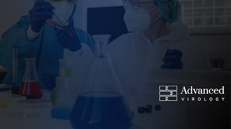 Scientist behind beakers 